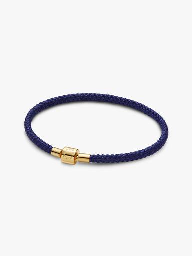 Skinnende blåt armbånd med snor